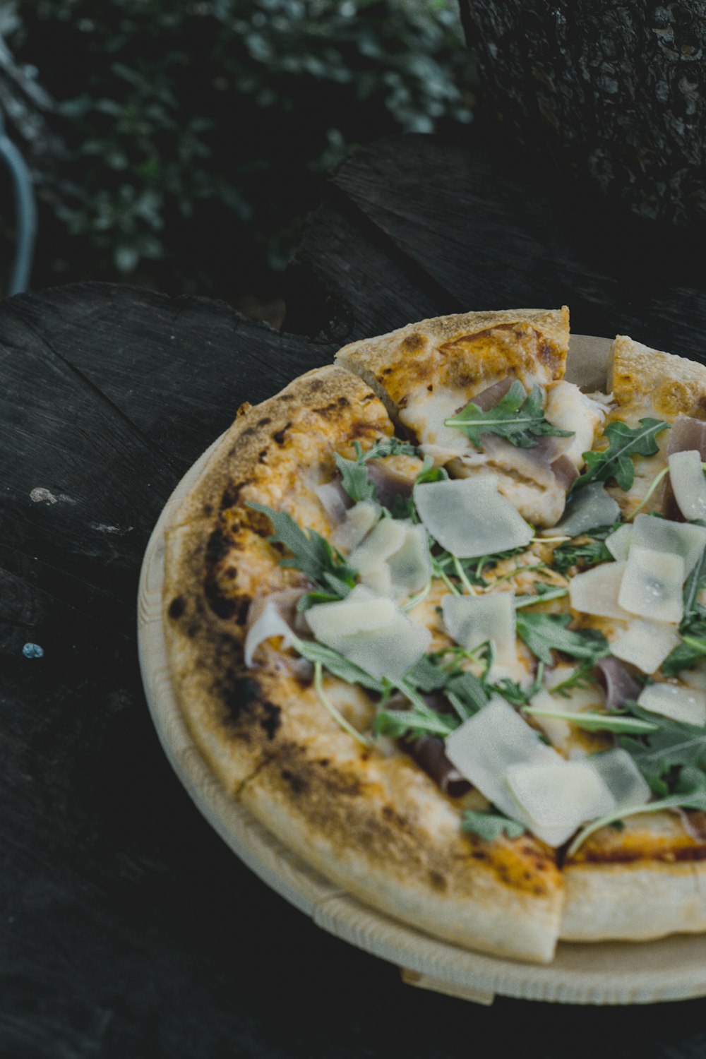 a pizza sitting on top of a wooden table