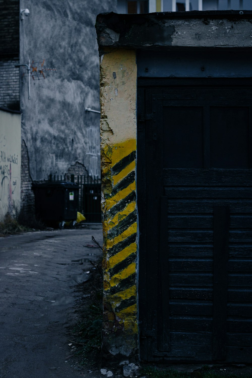 a black and yellow building with a black door