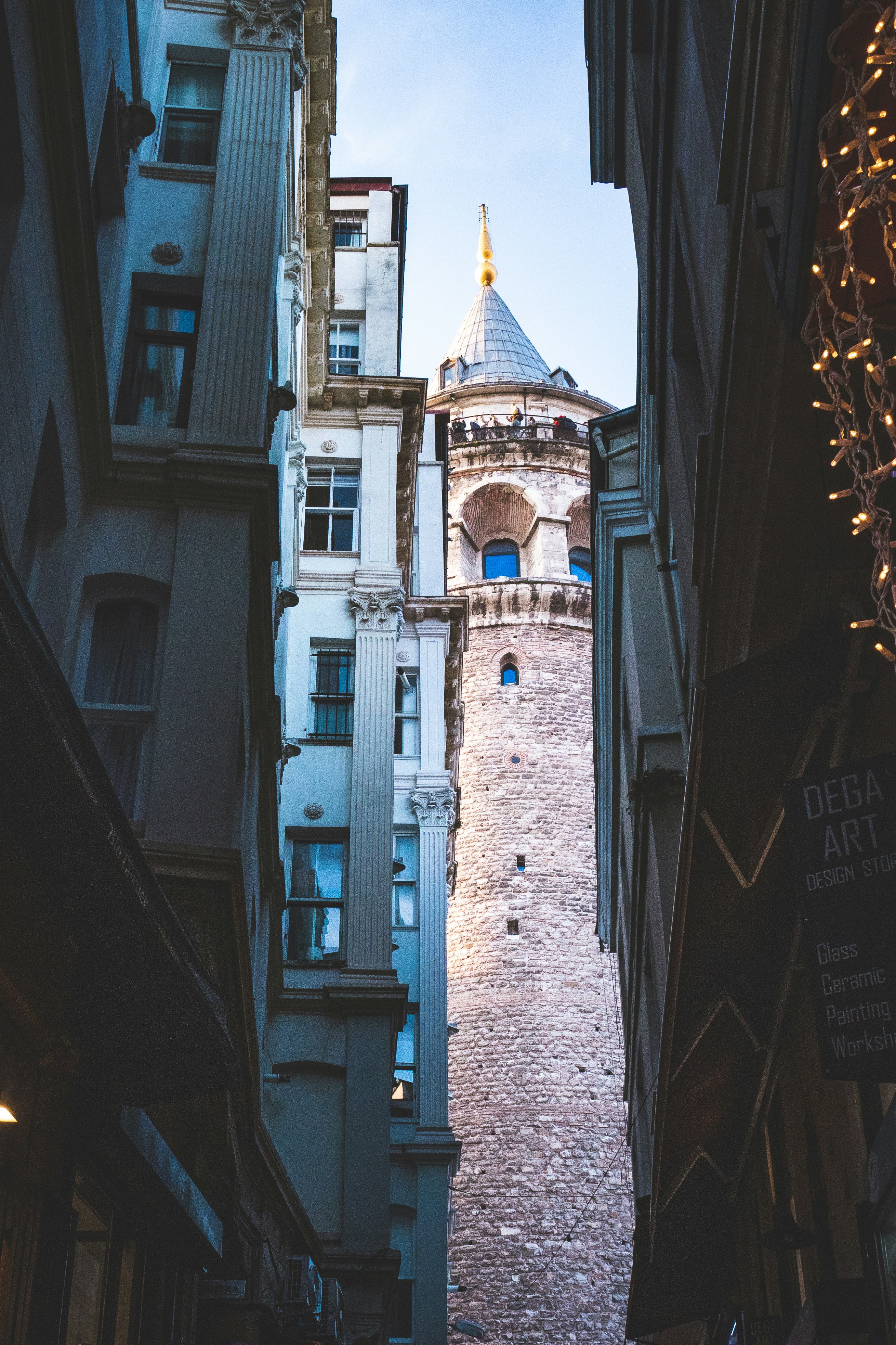 a tall brick building with a clock on it's side