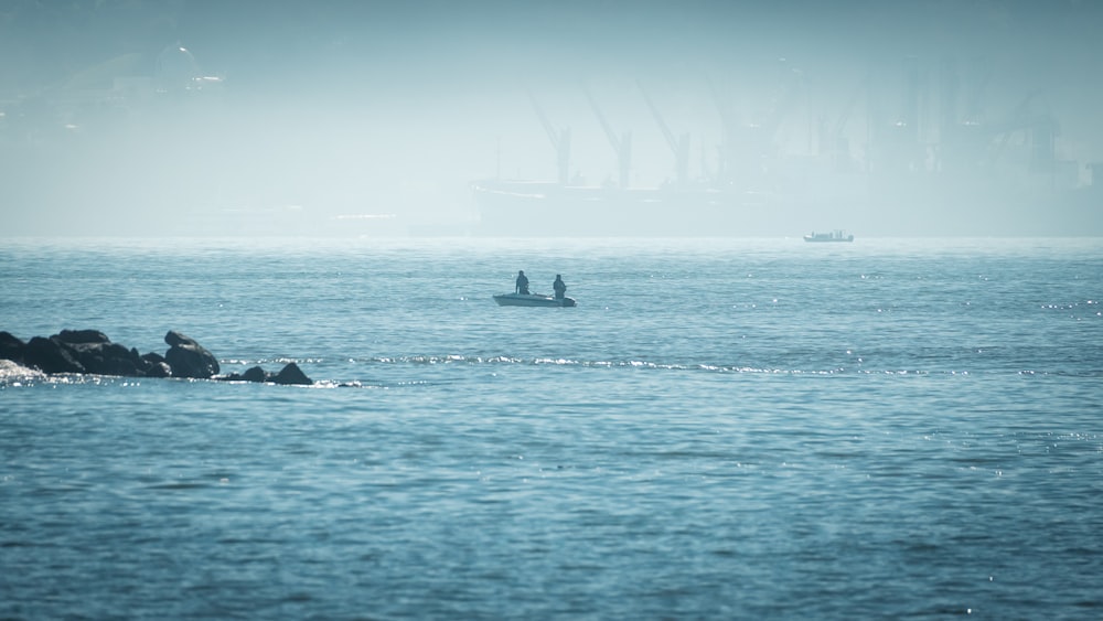 a couple of boats floating on top of a large body of water