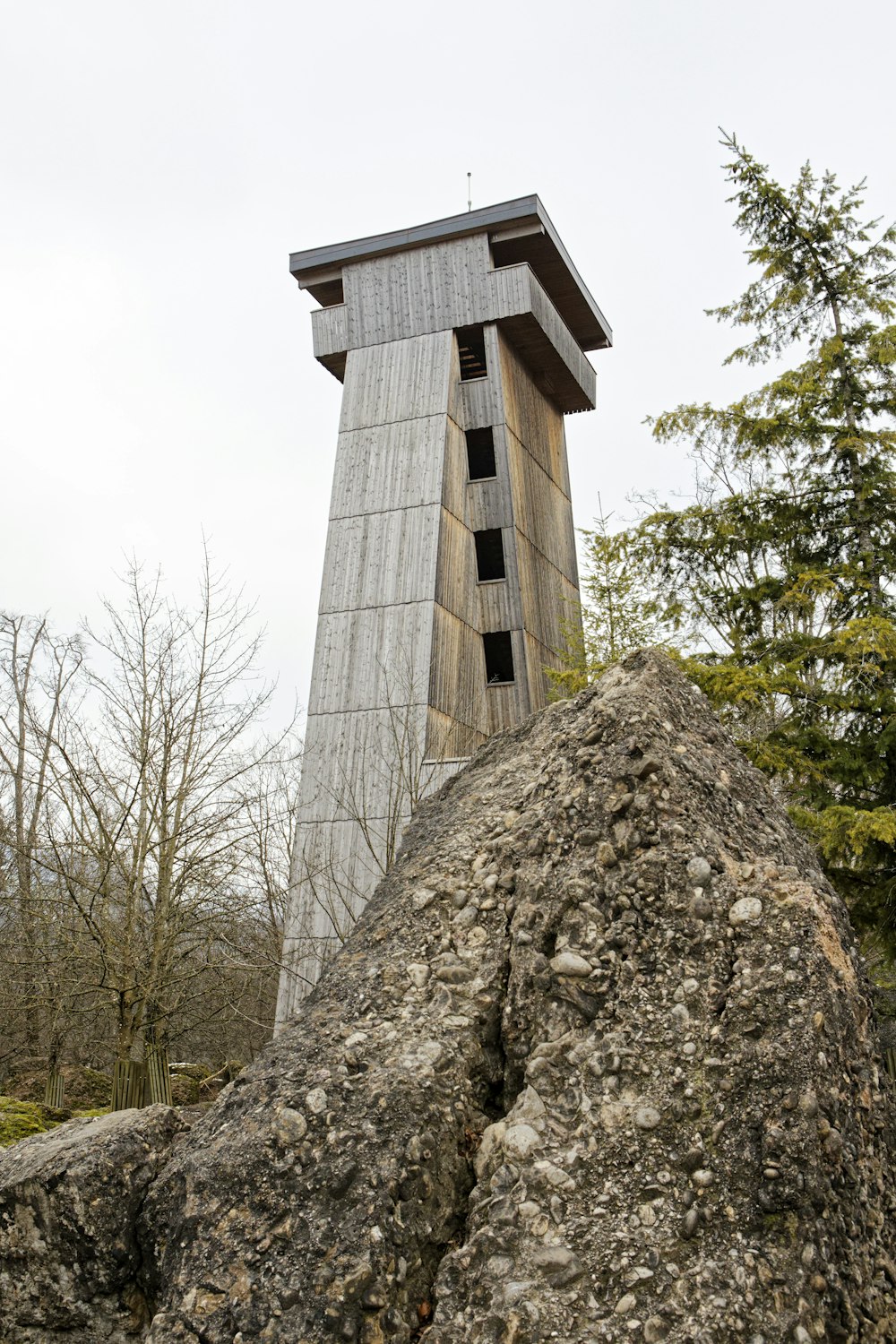 a very tall tower sitting above a pile of rocks