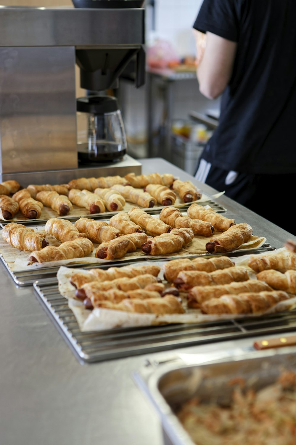 several trays of pastries are lined up on a counter