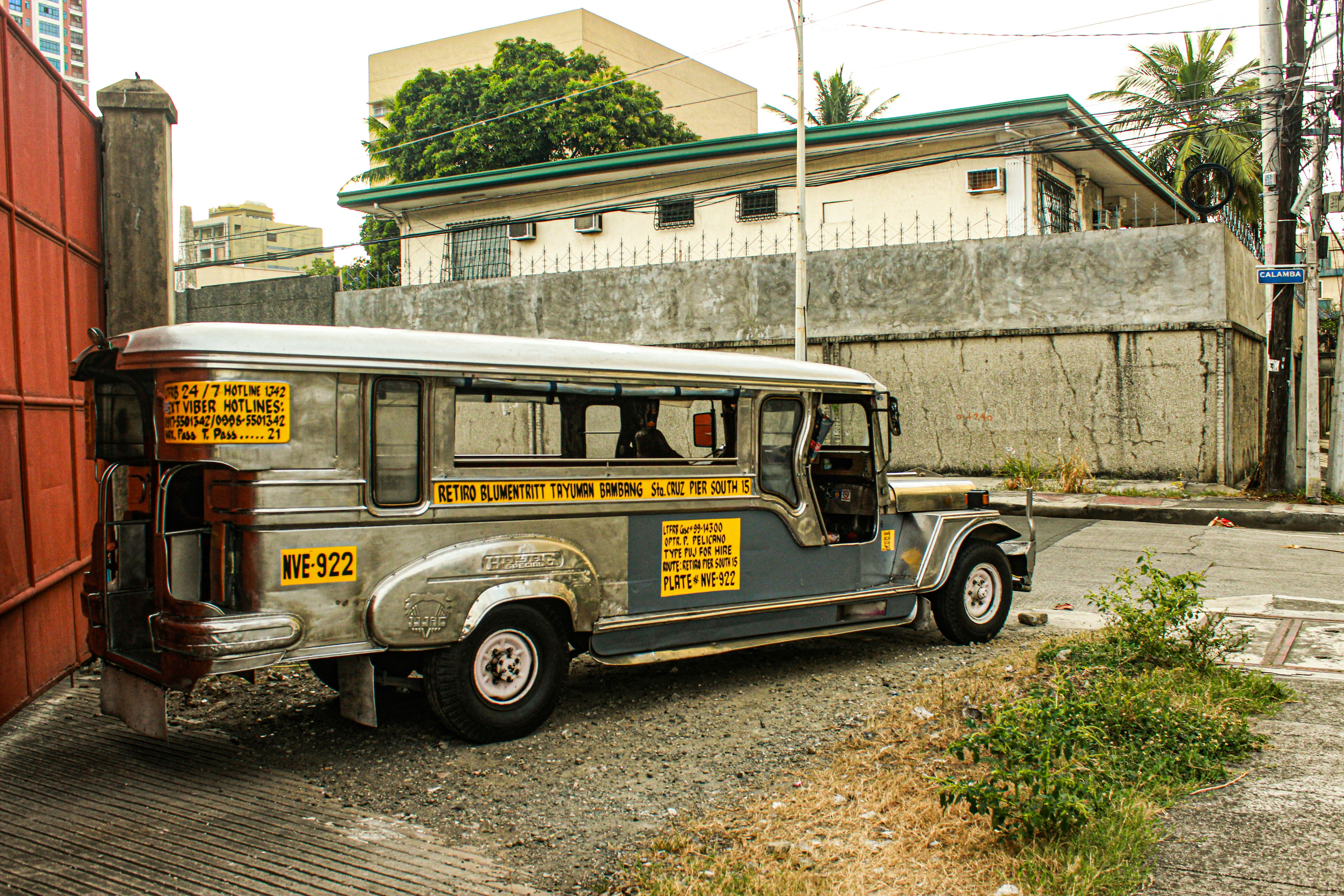 an old bus parked on the side of the road, "Philippine Jeepney is Here to Stay"