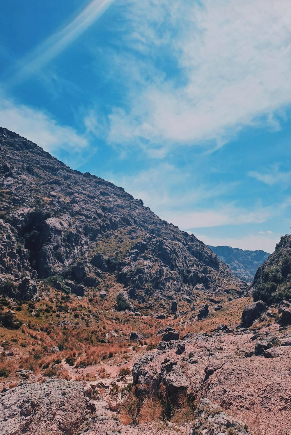 a rocky landscape with a mountain in the background