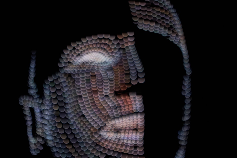 a close up of a person's face made out of circles