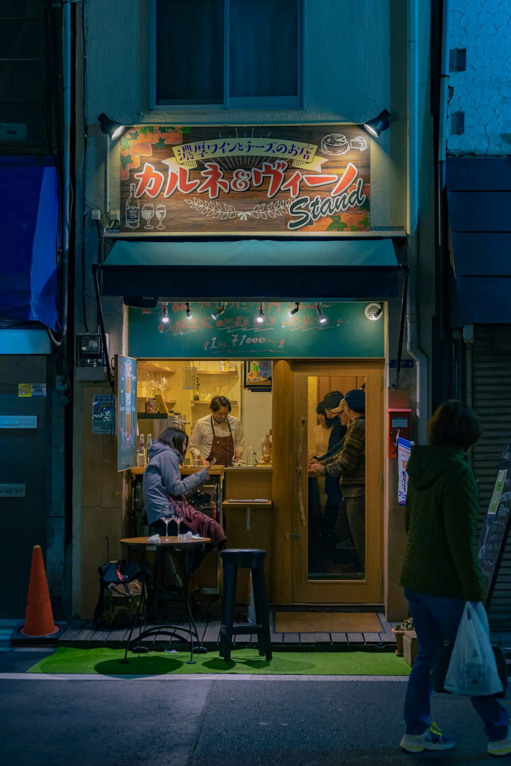 a group of people sitting at a table outside of a restaurant