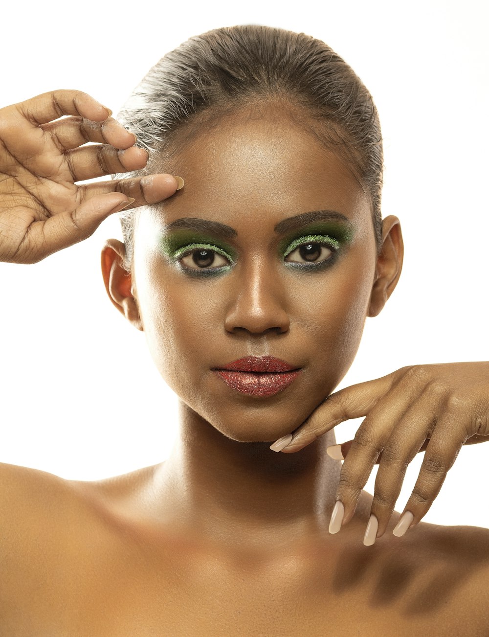 a woman with green eyeshades and a manicure