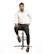 A stylish man with a perfectly trimmed beard and modern haircut sitting in a sleek barber chair.
