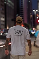 Model wearing an oversized t-shirt with edgy typography on a city street