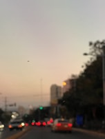 A calm street scene at dusk with blurred lights and gentle movement.