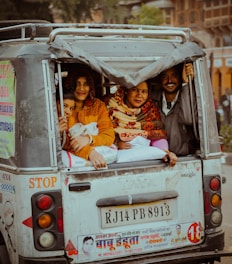 a group of people riding in the back of a truck