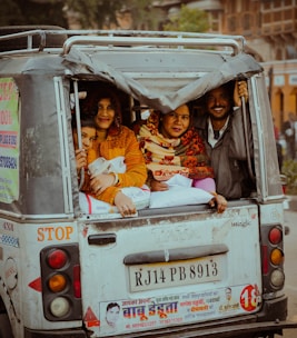 a group of people riding in the back of a truck