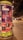 A cylindrical outdoor advertisement pillar displays multiple posters for upcoming music events. The prominent poster advertises Sr. Chinarro performing at Sala Wolf on February 10. Other posters announce concerts by Kevin Johansen on February 1, Christina Rosenvinge on February 4, and Núria Graham on February 17. The scene is set on a dimly lit street at night, with blurry figures and streetlights in the background.