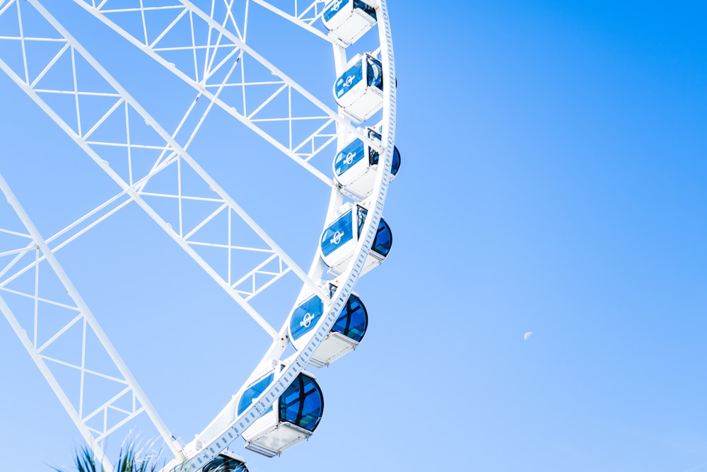 a large white ferris wheel against a blue sky