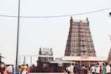 a group of people standing in front of a tall tower