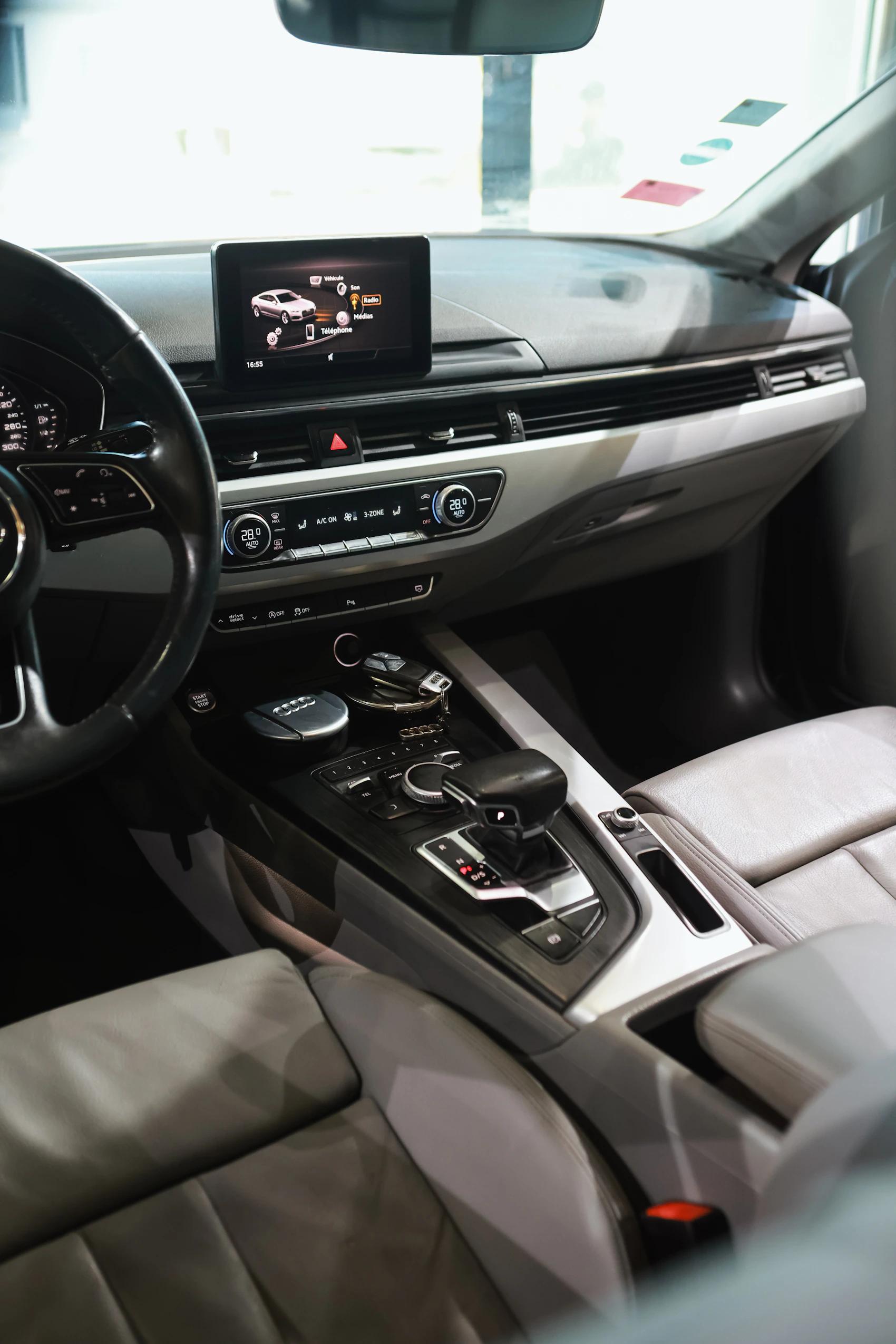 Vehicle center console with an integrated infotainment display and electronic controls