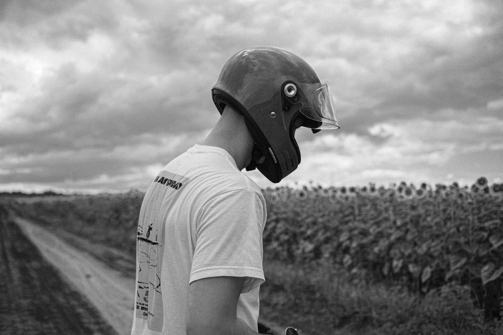 a man wearing a helmet and holding a skateboard