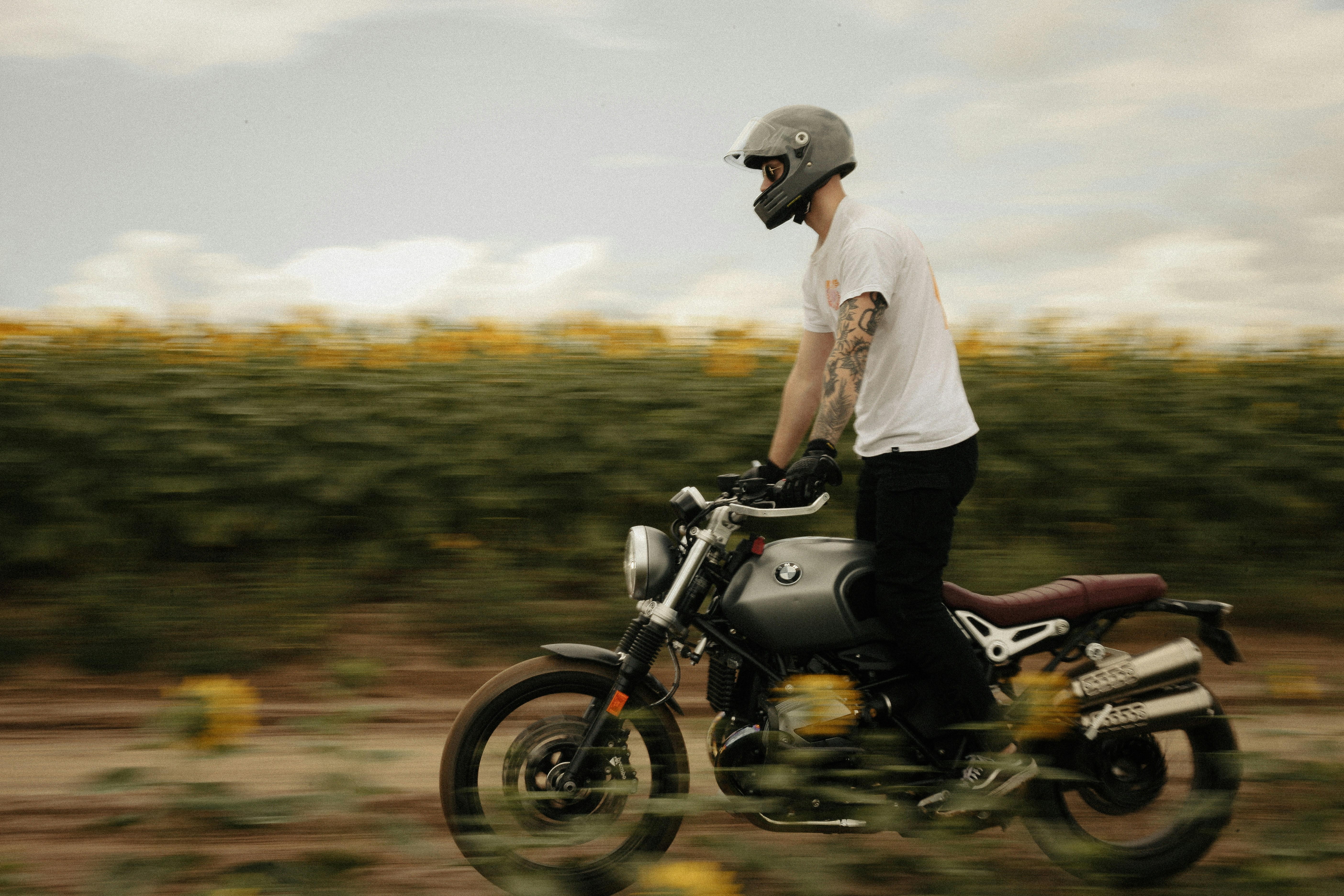 a man riding a motorcycle down a dirt road