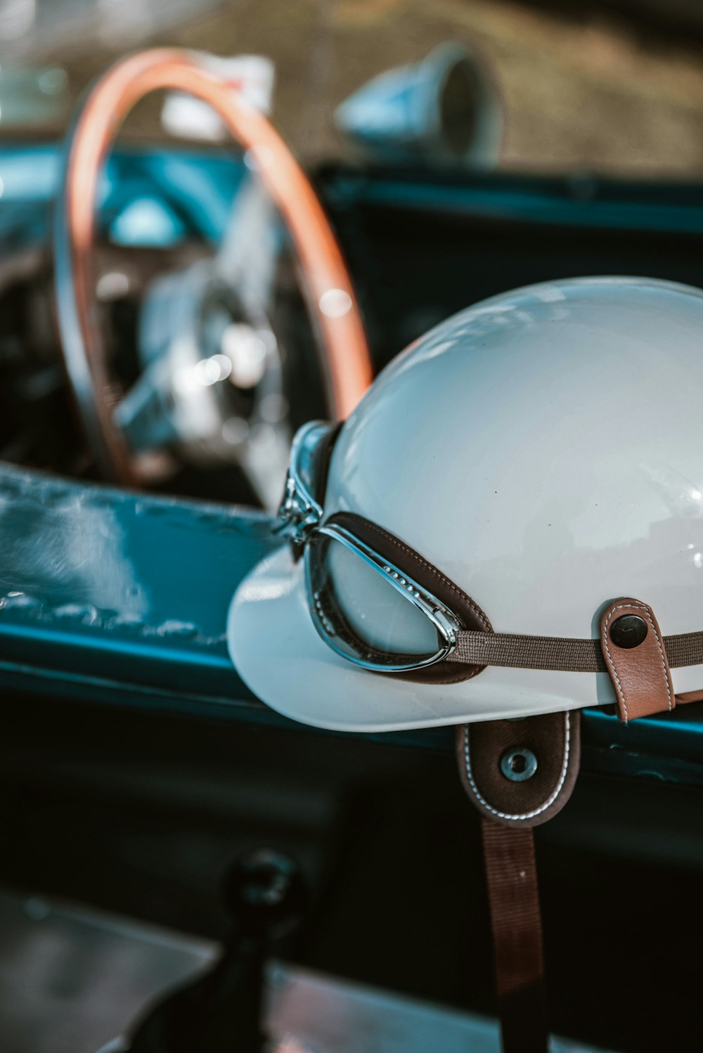 a white helmet sitting on top of a blue car