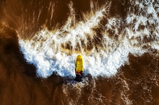 A surfer catching a wave with a GoPro attached to their board, capturing the thrill of the ocean