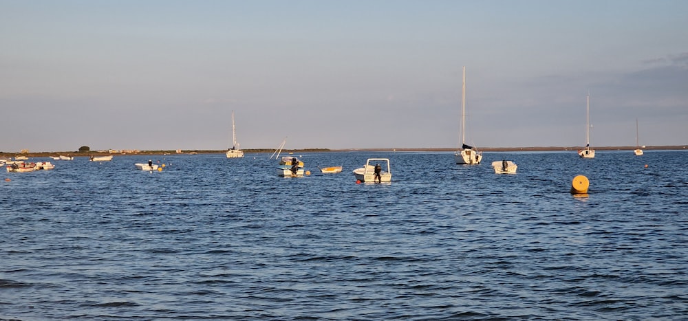 a group of boats floating on top of a large body of water