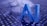 Large blue letters 'AI' stand prominently on a surface covered with a pattern of hexagonal shapes. Dark swirling lines intersect around the letters, creating a sense of motion and complexity. The background has a metallic sheen with a futuristic, digital style.