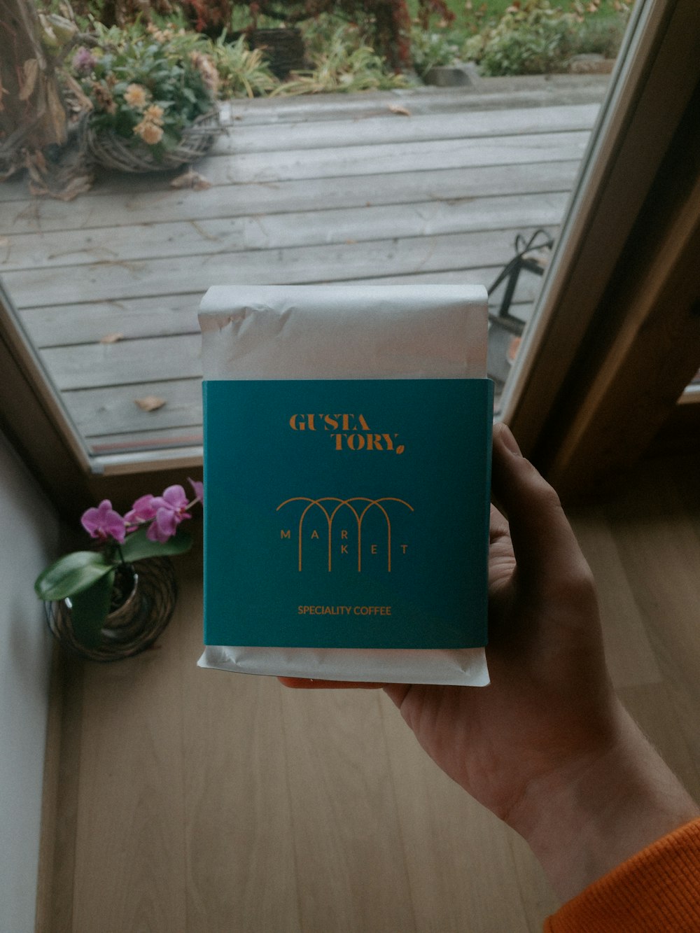 a person holding up a book in front of a door