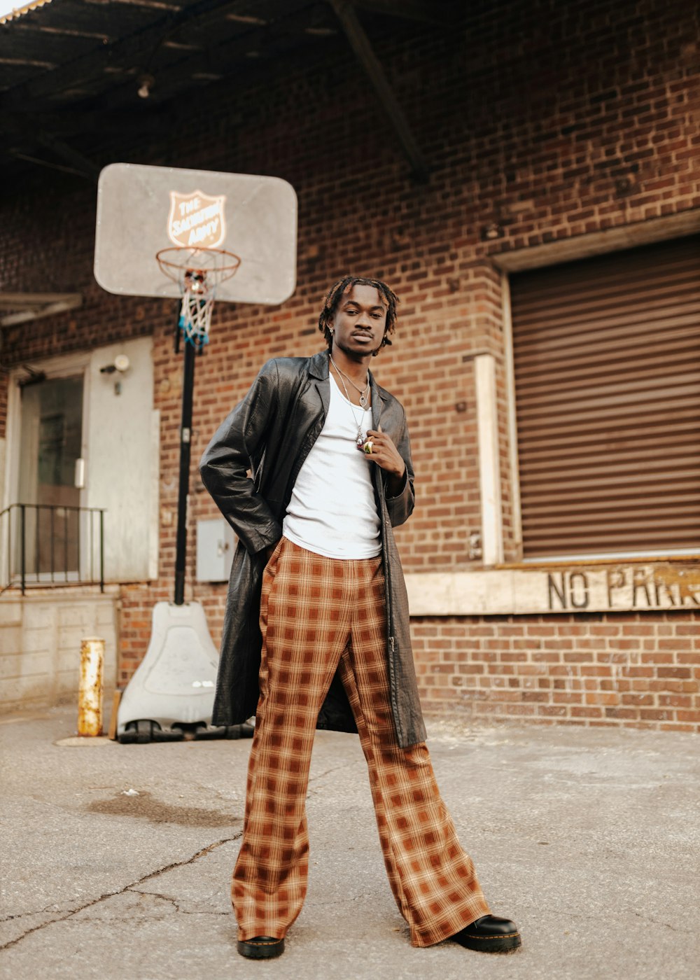 a man standing in front of a basketball hoop