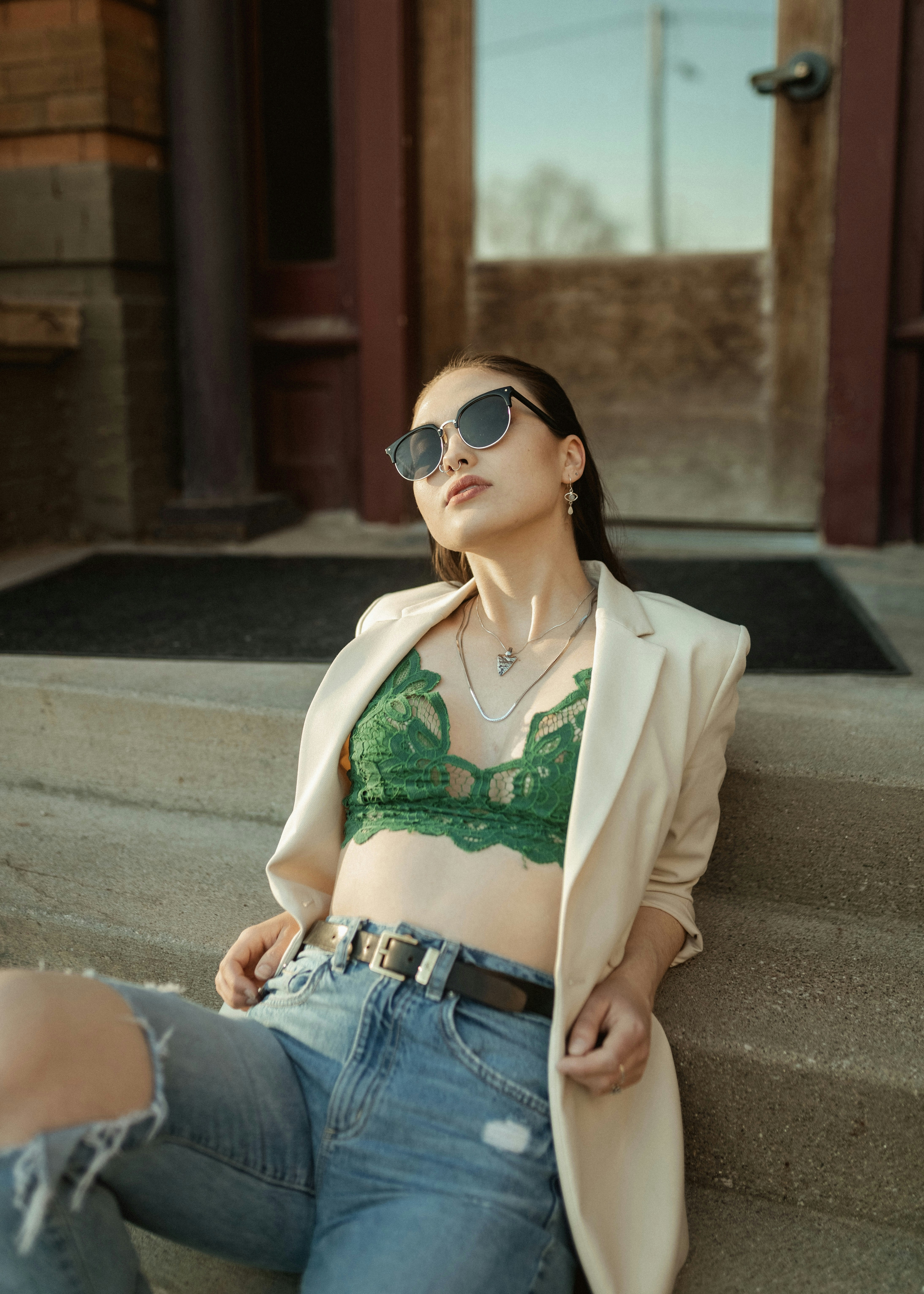 a woman sitting on the steps of a building
