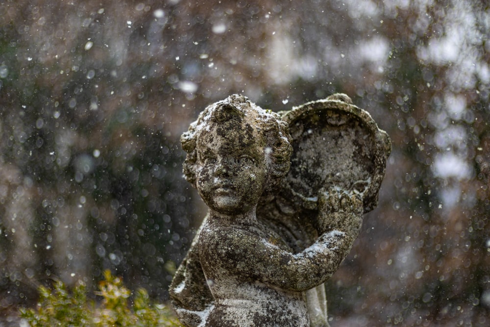 a statue of an angel in the snow