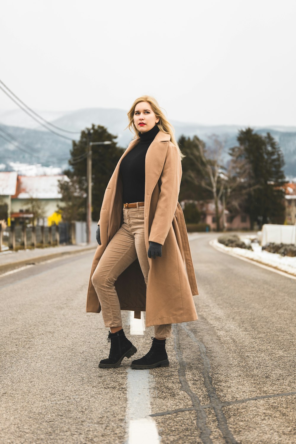 a woman standing on the side of a road