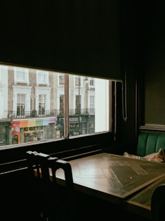 a table and chairs in front of a window