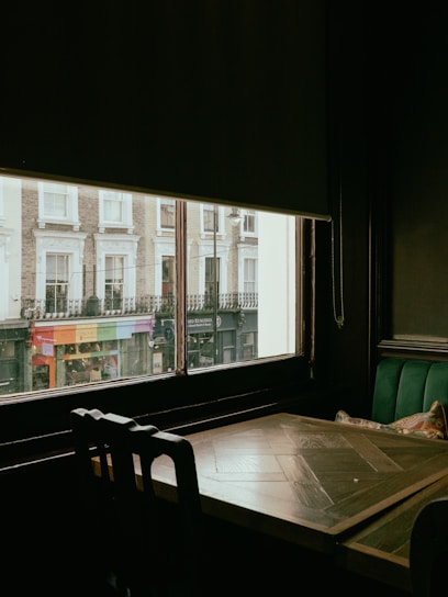 a table and chairs in front of a window