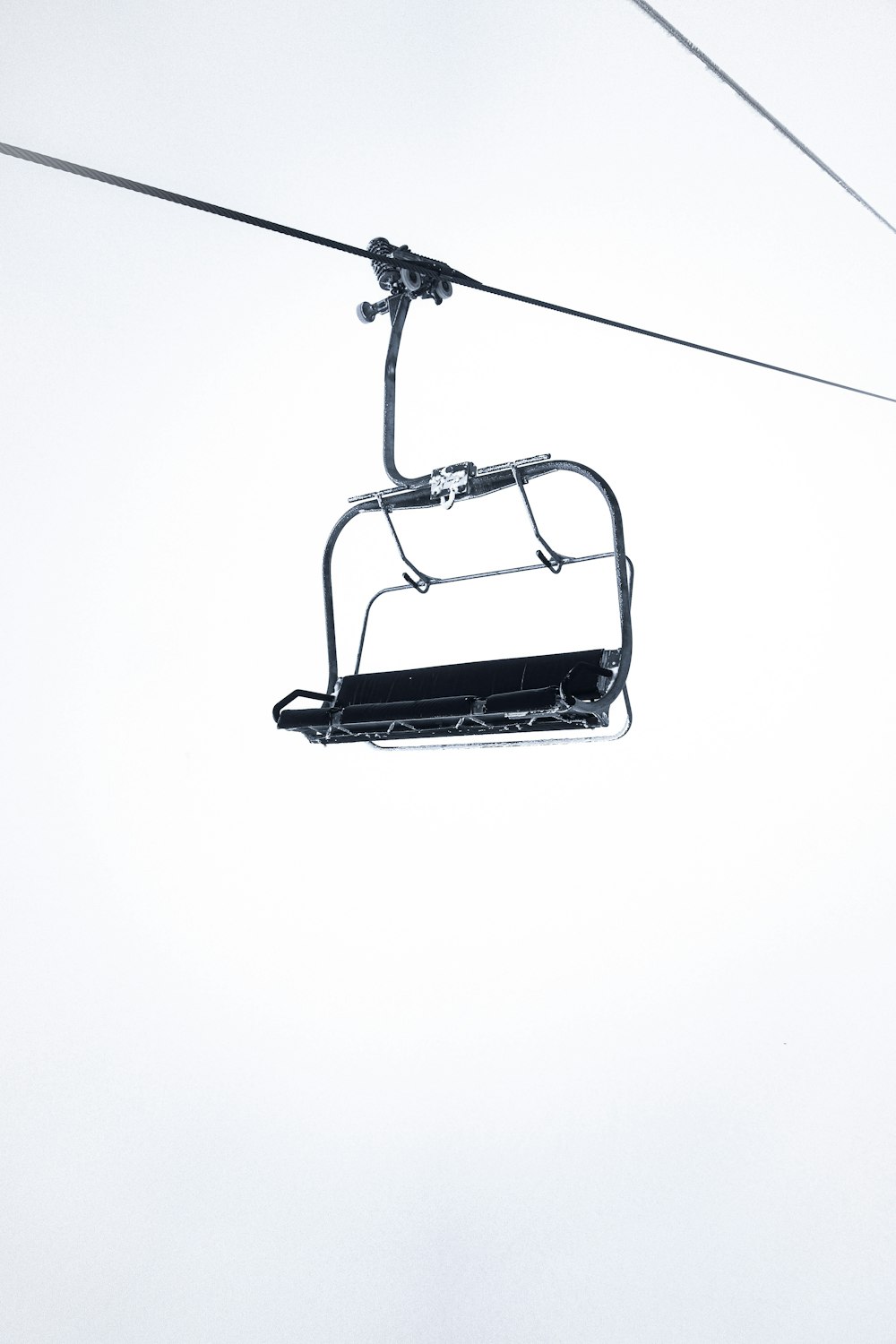 a black and white photo of a ski lift