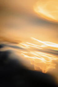 An abstract swirl of soft golden light symbolizing the beginning of a personal journey.