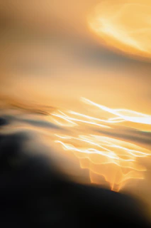 Abstract image of flowing golden lines over a dark background, illustrating financial flow and internal structure.