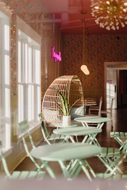 A cozy corner of Chillibees restaurant with emerald and gold accents, featuring a welcoming contact area.