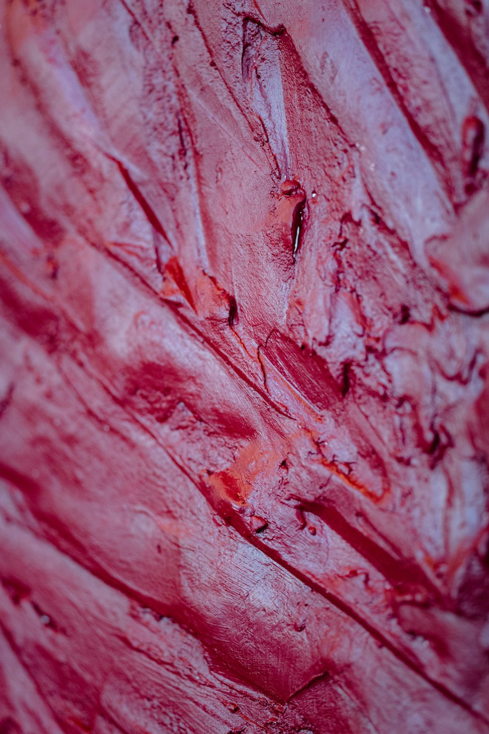 a close up of a piece of red paint
