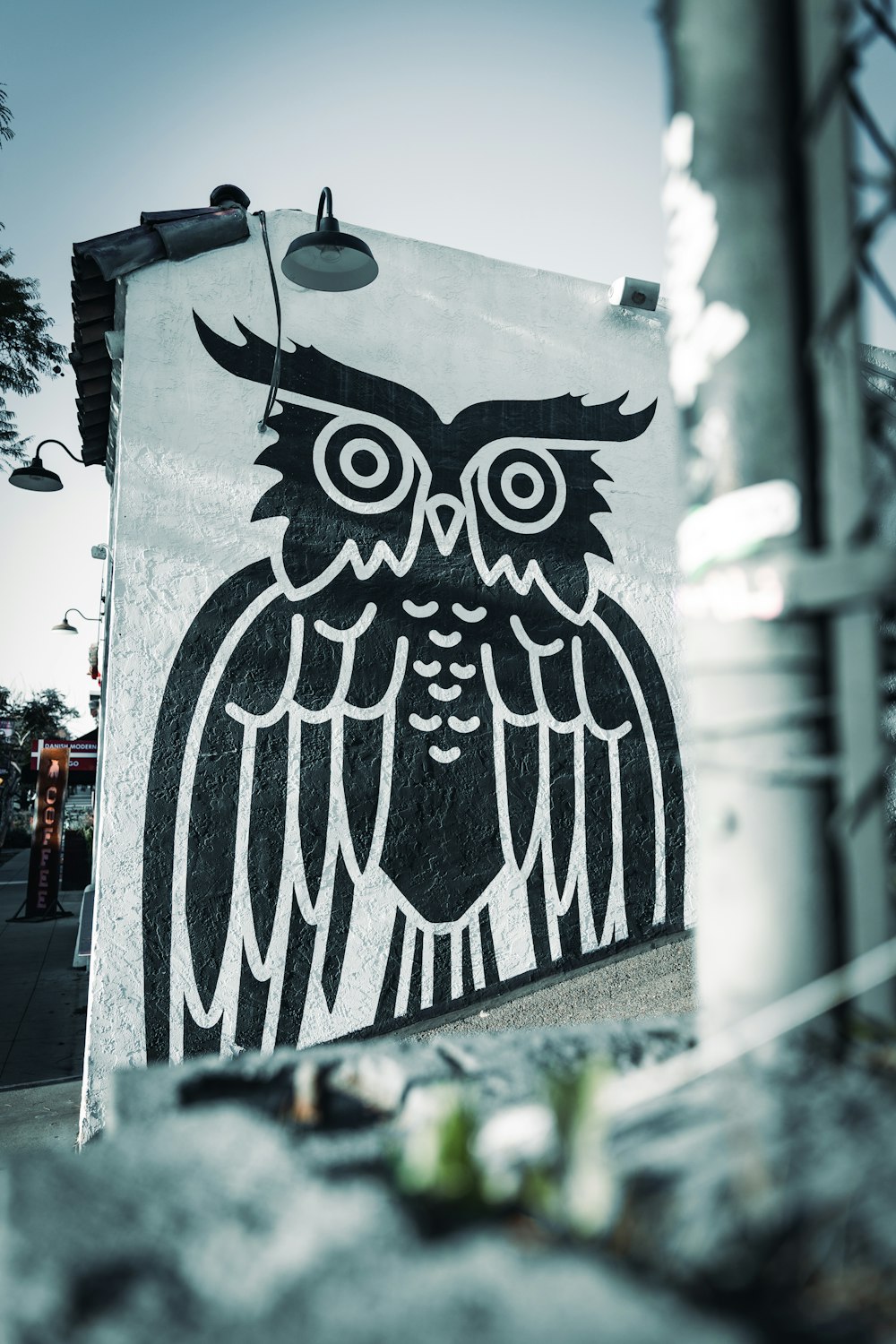 a black and white picture of an owl on a building