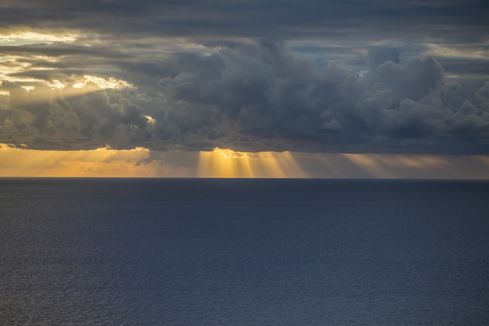 a large body of water under a cloudy sky