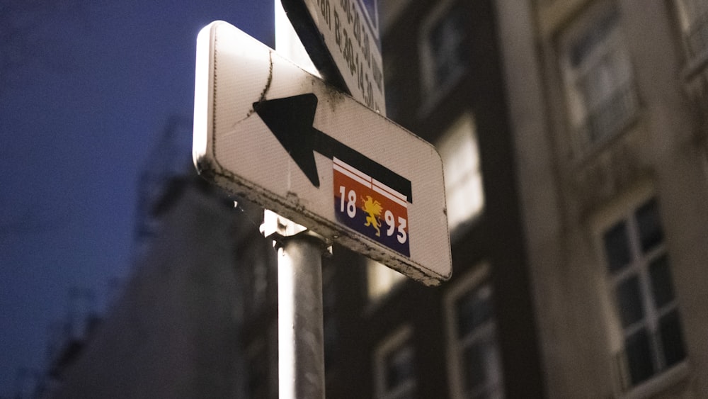 a close up of a street sign with a building in the background