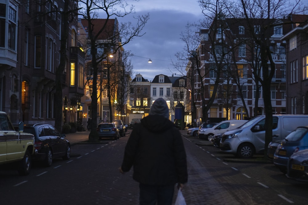 a person walking down a street at night