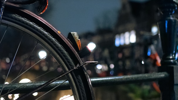 Sleek motorcycle tire shining under city lights on a wet street