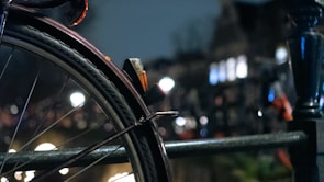 Close-up of a technician changing a flat tire on a busy city street.