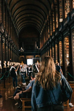 a person sitting in a chair in a library