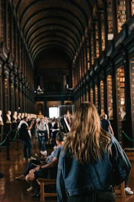 a person sitting in a chair in a library