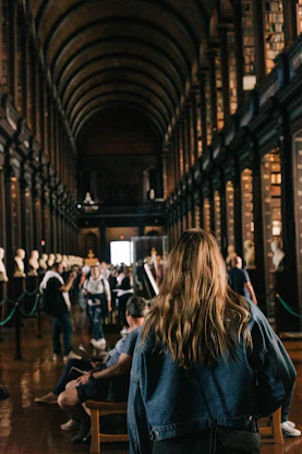 a person sitting in a chair in a library