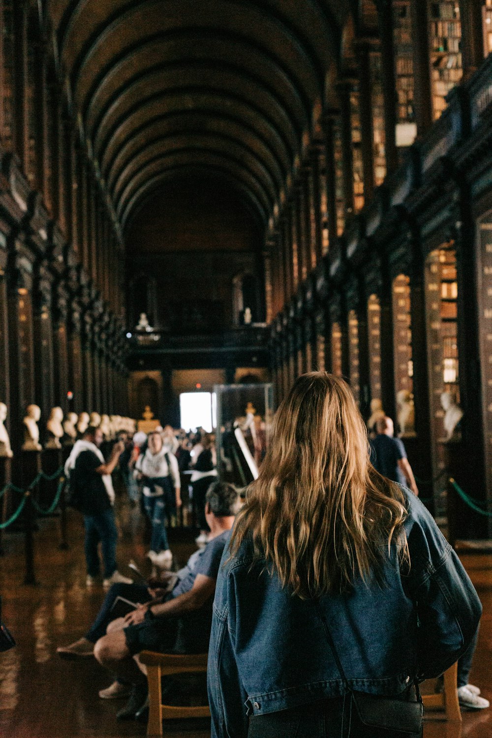 a person sitting in a chair in a library