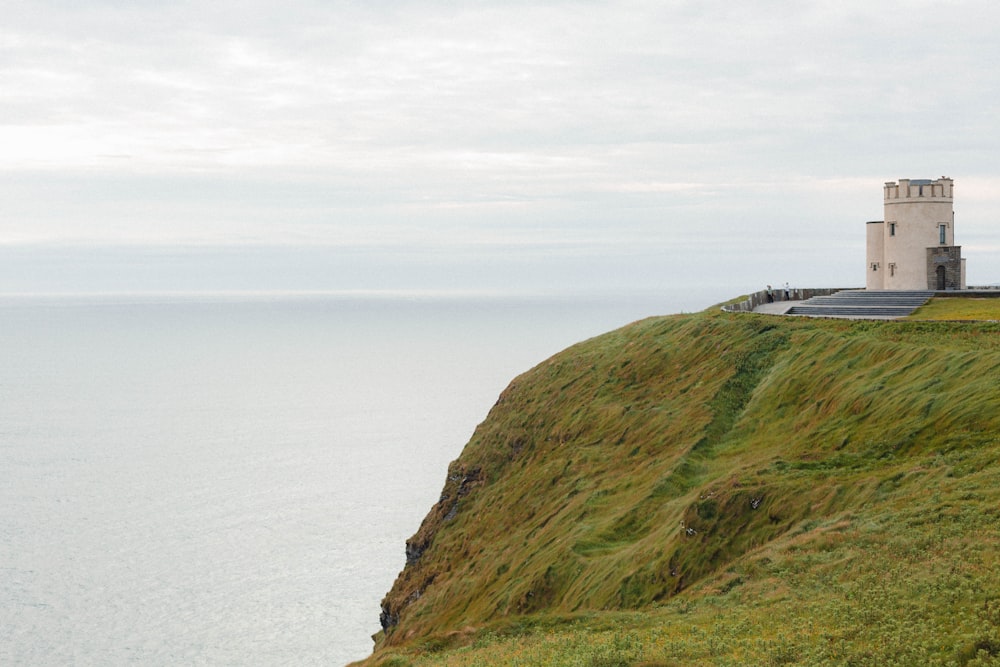 a lighthouse on a cliff overlooking the ocean