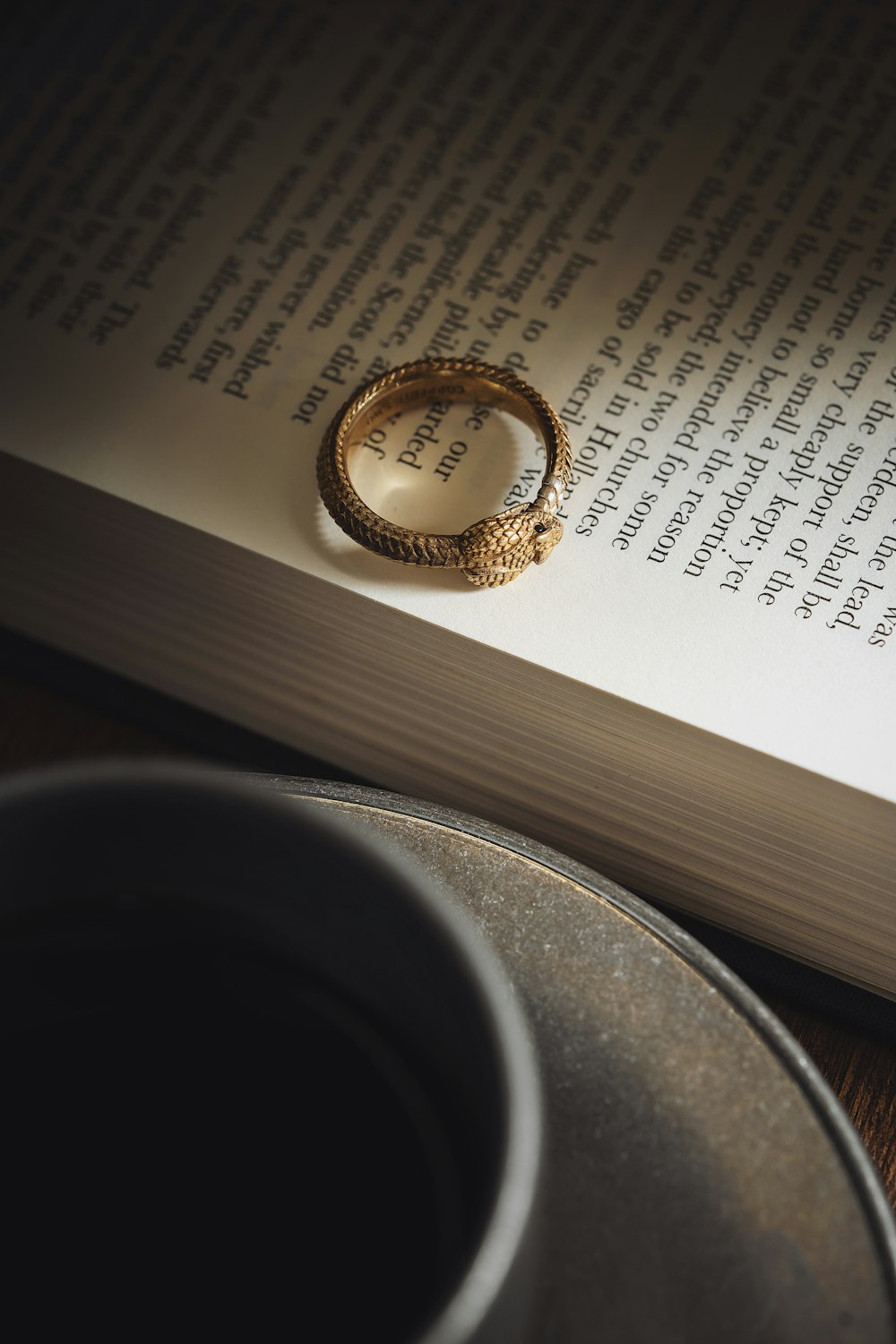 a gold ring sitting on top of an open book